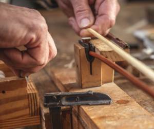 Photo of a luthier making a bow